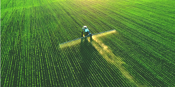 A tractor spraying a field