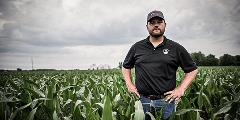 man standing in corn field